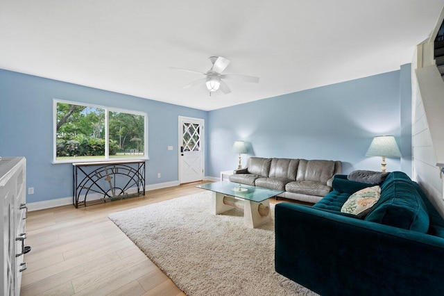 living room with ceiling fan and light hardwood / wood-style floors