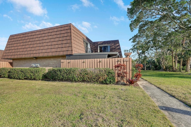 view of home's exterior with a lawn