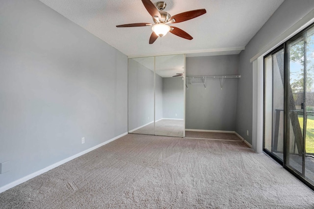 unfurnished bedroom with carpet, access to exterior, a closet, ceiling fan, and a textured ceiling