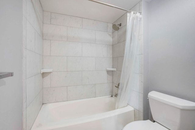 bathroom featuring shower / bathtub combination with curtain and toilet