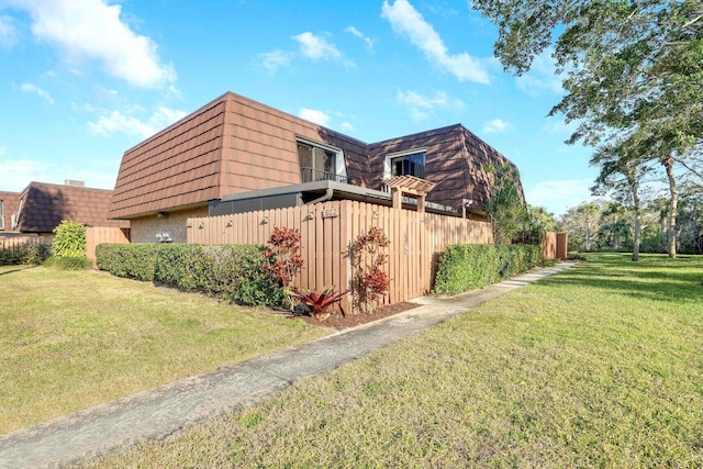 view of property exterior featuring a lawn