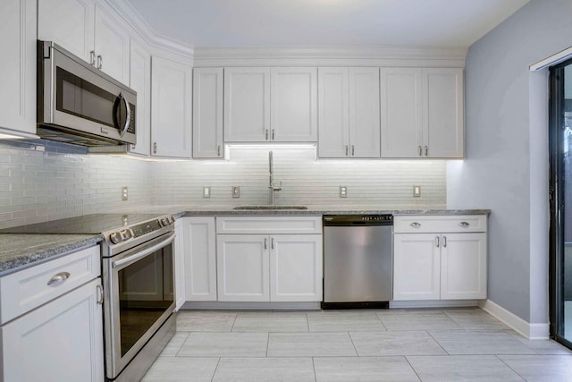 kitchen with white cabinets, stainless steel appliances, and light stone counters