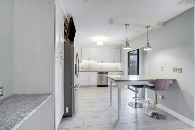 kitchen with stainless steel appliances, light stone countertops, white cabinets, pendant lighting, and sink