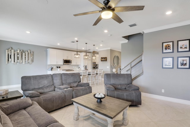 tiled living room featuring ornamental molding and ceiling fan
