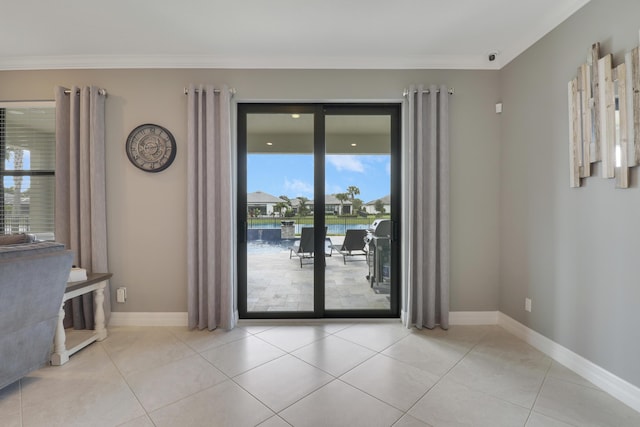 empty room featuring ornamental molding, a water view, and light tile patterned floors