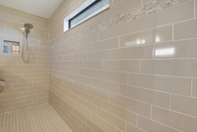 bathroom with tiled shower