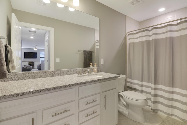 bathroom with tile patterned flooring, vanity, walk in shower, and toilet