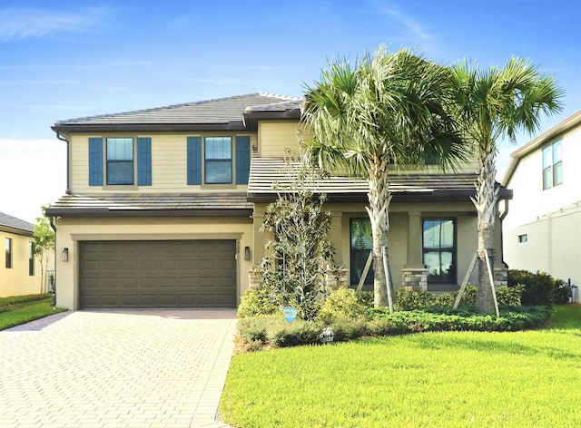 view of front of home featuring a garage and a front lawn