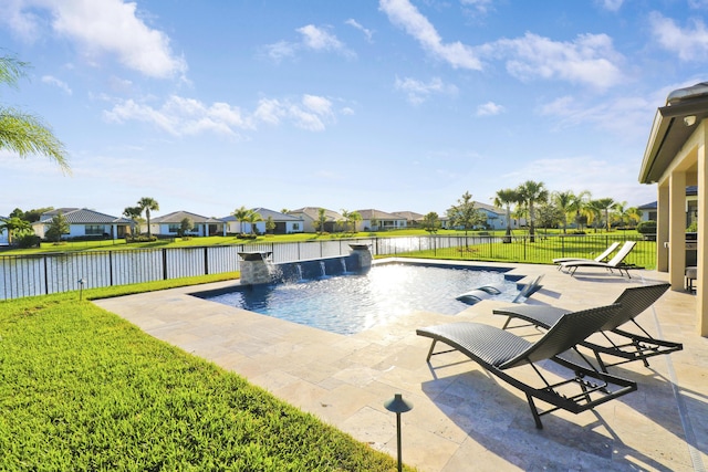 view of swimming pool featuring a water view, pool water feature, a patio area, and a lawn