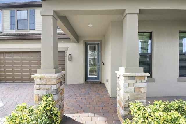doorway to property with a garage
