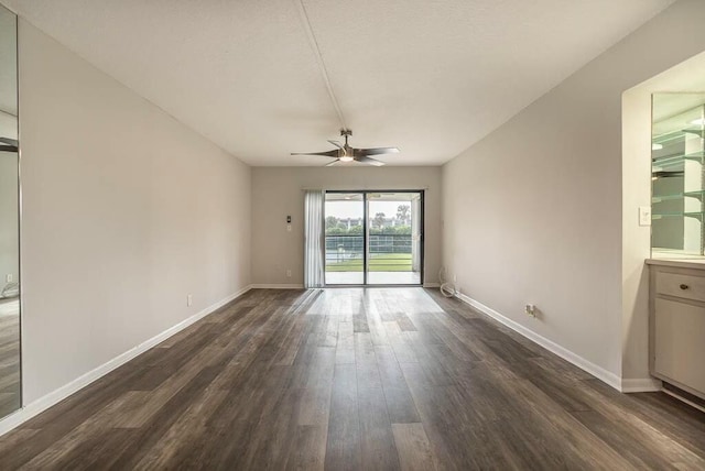 empty room featuring dark hardwood / wood-style flooring and ceiling fan