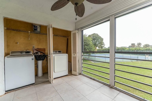 unfurnished sunroom with washer / dryer and ceiling fan