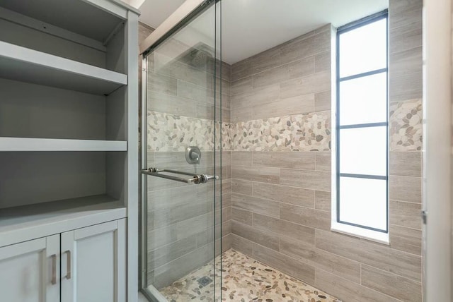 bathroom featuring a shower with door