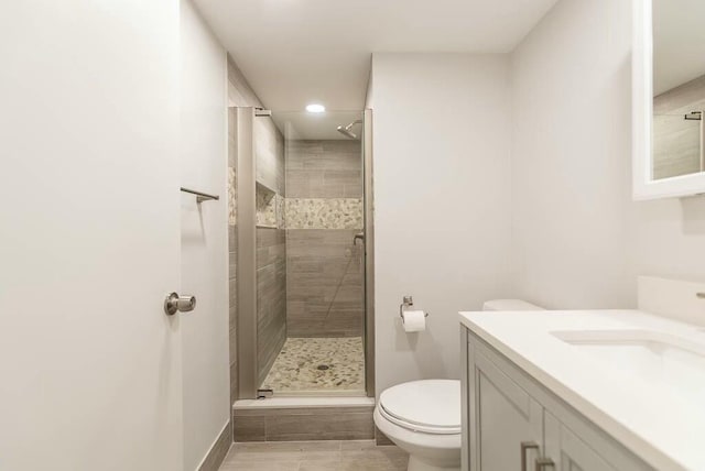 bathroom featuring walk in shower, vanity, and toilet