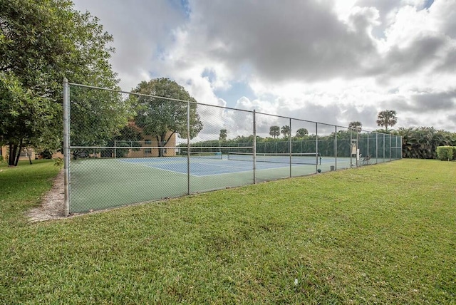 view of sport court featuring a lawn