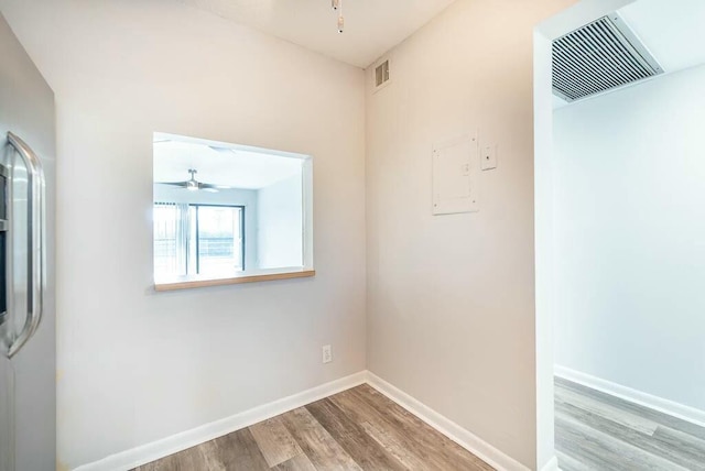 empty room with hardwood / wood-style floors and ceiling fan