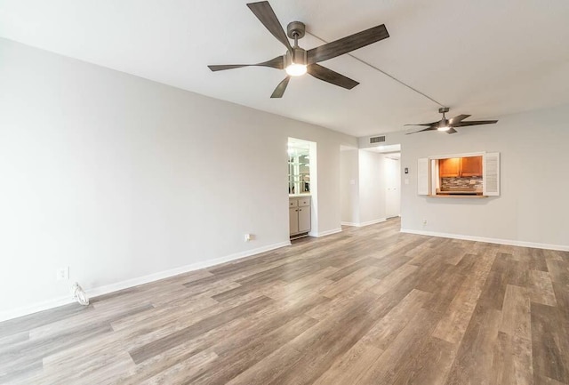 unfurnished living room featuring light hardwood / wood-style flooring and ceiling fan