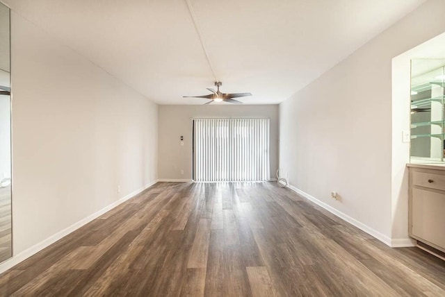 interior space featuring dark wood-type flooring and ceiling fan