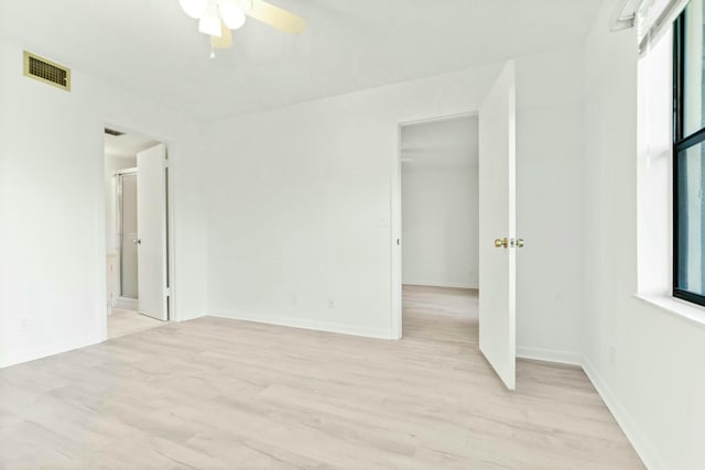 empty room with ceiling fan and light hardwood / wood-style floors