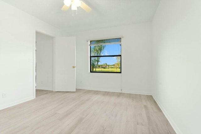 empty room with ceiling fan and light hardwood / wood-style floors