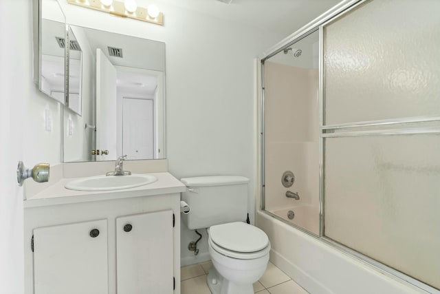 full bathroom with vanity, tile patterned floors, shower / bath combination with glass door, and toilet