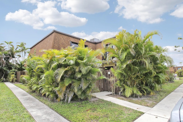 view of home's exterior featuring a yard and fence