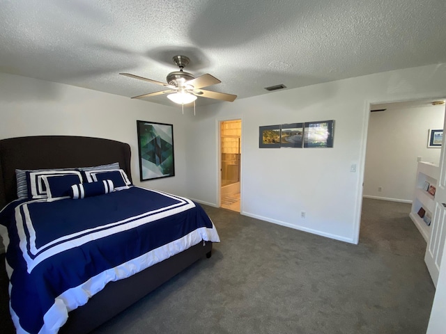 bedroom featuring ceiling fan, dark carpet, and a textured ceiling