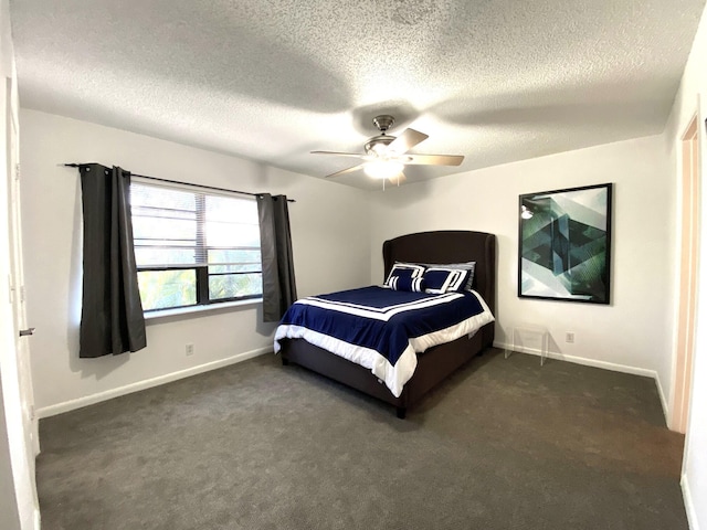 bedroom featuring ceiling fan, dark carpet, and a textured ceiling