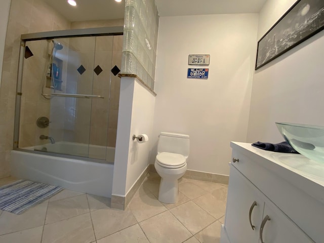 full bathroom featuring tile patterned floors, vanity, toilet, and combined bath / shower with glass door