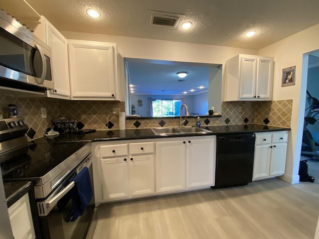 kitchen featuring white cabinetry, sink, light hardwood / wood-style flooring, and stainless steel appliances