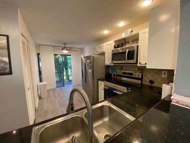 kitchen featuring white cabinetry, appliances with stainless steel finishes, sink, and backsplash