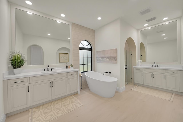 bathroom with vanity, separate shower and tub, and hardwood / wood-style floors