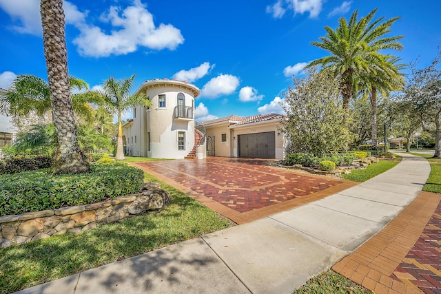 mediterranean / spanish-style home with a garage