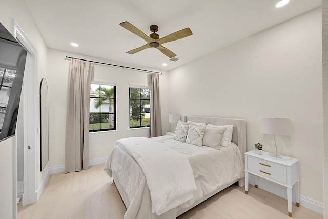 bedroom with ceiling fan and light hardwood / wood-style floors