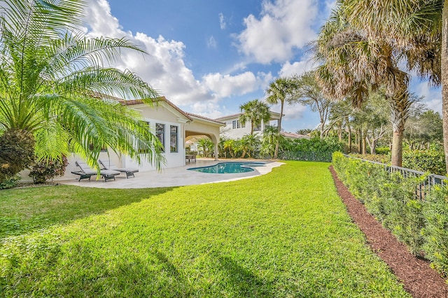 view of yard with a fenced in pool and a patio area