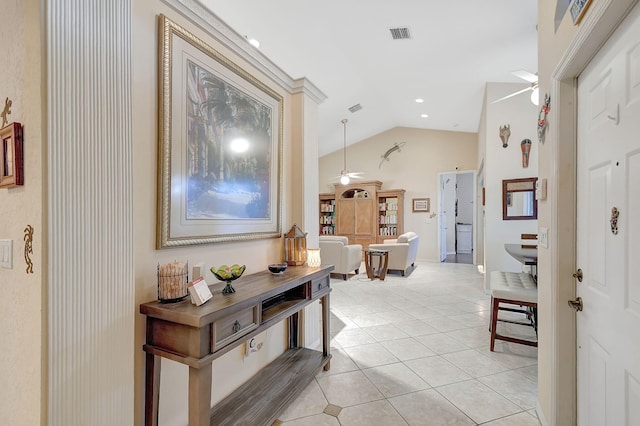 corridor featuring vaulted ceiling and light tile patterned floors