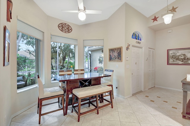 dining space featuring ceiling fan, a high ceiling, and light tile patterned floors