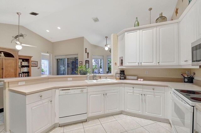 kitchen featuring white cabinetry, sink, ceiling fan, kitchen peninsula, and white appliances