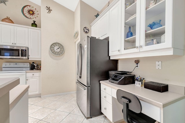 kitchen with white cabinetry, stainless steel appliances, and light tile patterned flooring