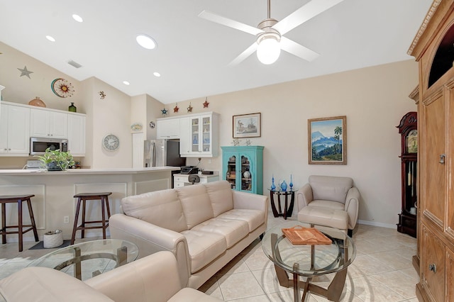 tiled living room with ceiling fan and lofted ceiling