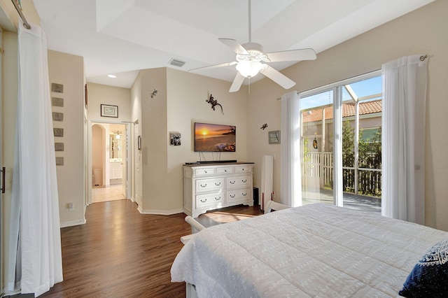 bedroom featuring connected bathroom, access to outside, dark hardwood / wood-style floors, and ceiling fan