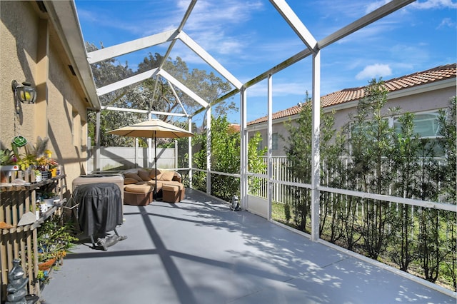 view of patio featuring a lanai