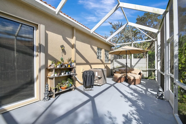 view of patio featuring a lanai and central AC unit