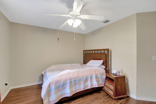 bedroom with wood-type flooring and ceiling fan