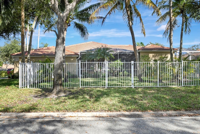 mediterranean / spanish-style house with a lanai and a front yard