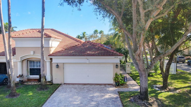 mediterranean / spanish-style home with a garage and a front yard