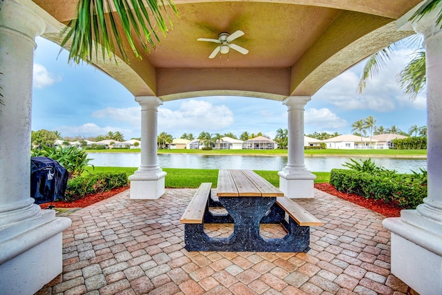 view of patio featuring a water view and ceiling fan