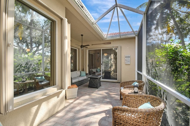 sunroom with a skylight and ceiling fan