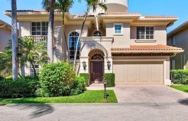 mediterranean / spanish home with a garage