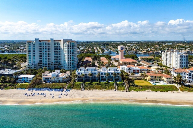 drone / aerial view featuring a water view and a beach view